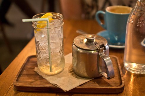 Earl grey iced tea; the glass jar has a dash of elderflower syrup in the bottom; the tea is poured on top